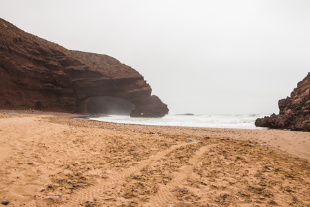 Coast, wave, beach and a large rock with archの写真素材
