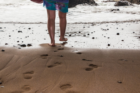 Coast, waves and beach with yellow sand and small pebblesの写真素材