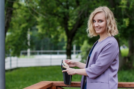 Portrait attractive girl with blond hair in the summer parkの写真素材