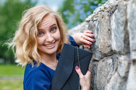 Portrait attractive girl with blond hair in the summer parkの写真素材