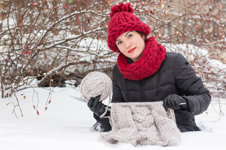 Cute girl in a warm hat in winter dayの写真素材