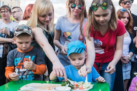 Russia, Kirov - June, 12, 2017: People in the open festival called Delicious Vyatka - Vkusnaya Vyatka during barbecue in the birthday of Kirov city in 2017のeditorial素材