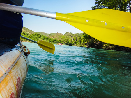 Paddle, river and the side of the boat during rafting in river in mountain