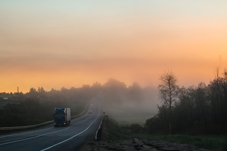 Beautiful sunrise and fog in early morning in a summerの写真素材