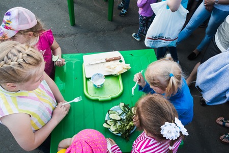 Russia, Kirov - June, 12, 2017: People in the open festival called Delicious Vyatka - Vkusnaya Vyatka during barbecue in the birthday of Kirov city in 2017のeditorial素材