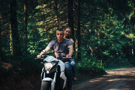 The motorcyclist and the girl on the roadの写真素材