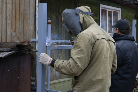 Welder in the village doing his job in an autumn day