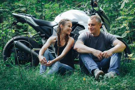 The motorcyclist and the girl in the forest