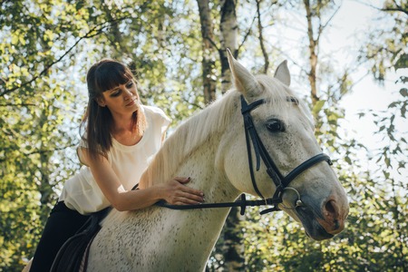 Girl and horse in the woods