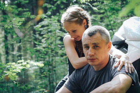 Adult man and a young girl in the forest