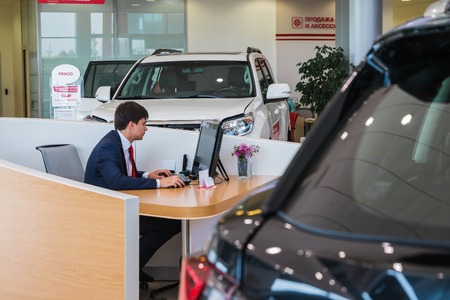 Russia, Kirov - August 21, 2017: Manager and car in showroom of dealership Toyota in Kirov city in 2016のeditorial素材