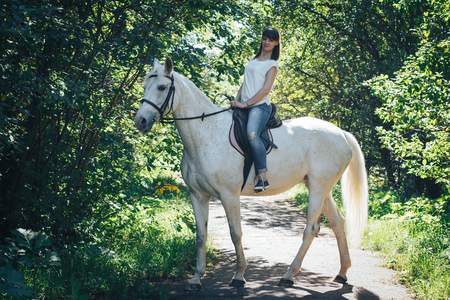 Girl and horse in the woodsの写真素材