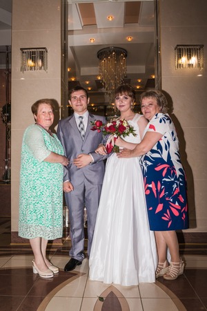 The bride and groom in the registry office during marriage and relatives aroundのeditorial素材