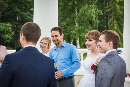 Russia, Kirov - July, 21, 2017: The bride, groom and guests outdoors after the marriage in Kirov city in 2017のeditorial素材