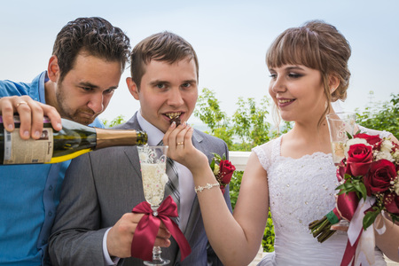 Russia, Kirov - July, 21, 2017: The bride, groom and their friend outdoors after the marriage in Kirov city in 2017のeditorial素材
