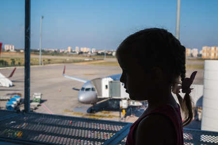 Turkey, Alanya - June, 29, 2017: Modern passenger airplane parked to terminal building gate is seen through of windowのeditorial素材