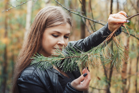 Portrait of nice girl in a forest in an autumnの写真素材