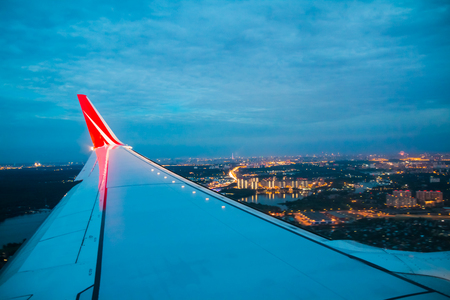 Wing of airplane Red line company flying above the Earthのeditorial素材