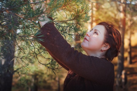 Woman in a forest in an autumn dayの写真素材