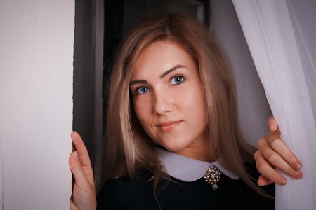 Portrait of a nice blond girl indoorsの写真素材