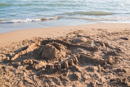 Castle is made by sand and waves of sea are backgroundの写真素材
