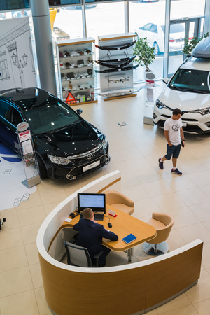 Russia, Kirov - August 21, 2017: Manager and car in showroom of dealership Toyota in Kirov city in 2016のeditorial素材