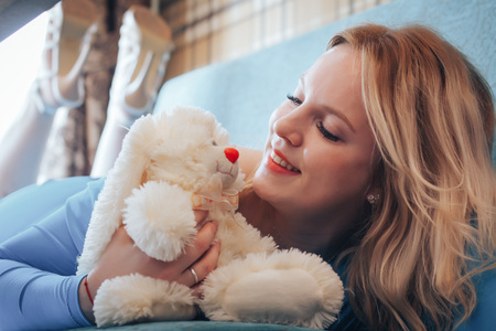 Blond woman in blue dress have rest in cafeの写真素材