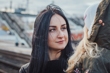 Mother and daughter at the train station in a dayの写真素材