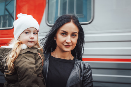 Mother and daughter at the train station in a dayの写真素材