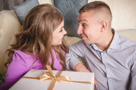 Nice couple in the room with the giftsの写真素材