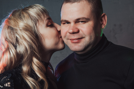 Couple in black dresses during dramatic image shooting in studio and spotlightsの写真素材