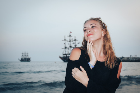Blond teenager girl on the beach near sea or oceanの写真素材