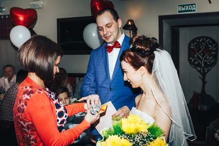 Kirov, Russia - November, 24, 2017: Guests congratulate the bride and groom in a decorated roomのeditorial素材