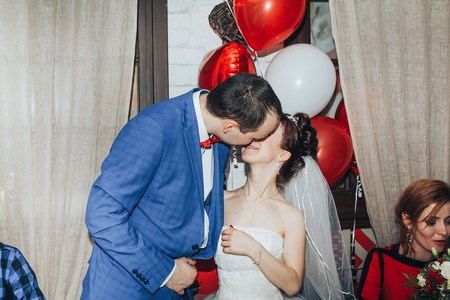 Kirov, Russia - November, 24, 2017: Bride and groom behind the decorated table at the wedding banquet and the guests sit nearestのeditorial素材