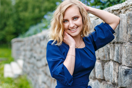 Portrait attractive girl with blond hair in the summer parkの写真素材