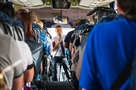 Jordan, Akaba - December 19, 2017: Tourists and a male tour guide with a microphone in the busのeditorial素材