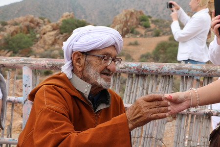 Agadir, Morocco - May 21, 2016: Old Moroccan man drinking tea with European touristsのeditorial素材