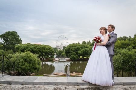 Bride and groom walking in summer park outdoorsの写真素材