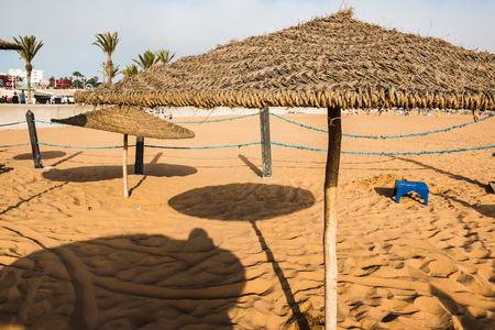 Beach umbrellas on the sandy beach by the seaの写真素材
