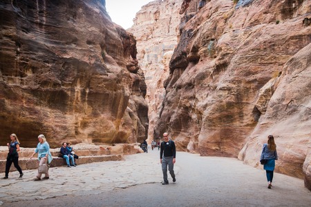 Petra, Jordan - December, 21, 2017: Siq canyon, which goes to the ancient city of Petra and tourists in itのeditorial素材