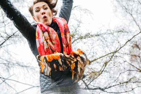 Funny beautiful girl do physical exercises in the Park in raining weatherの写真素材