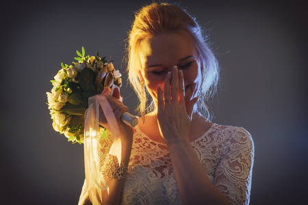 Beautiful bride in a white dress in the Studio during a photoshoot with nice lightの写真素材