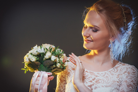 Beautiful bride in a white dress in the Studio during a photoshoot with nice lightの写真素材