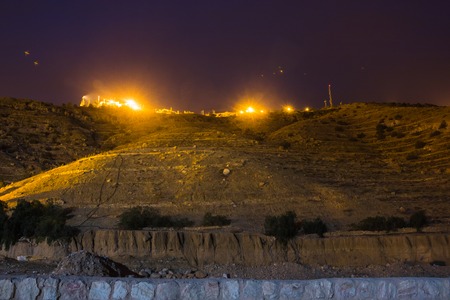 Light from the village in the mountains at dark nightの写真素材