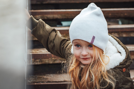 Portrait of small blonde girl in white hat outdoorsの写真素材