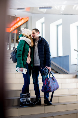 Couple of the travellers in warm clothes in the steps at the hall of stationの写真素材