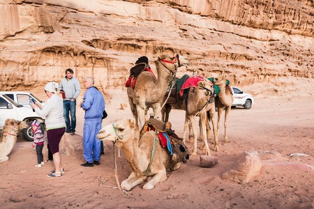 Wadi Rum, Jordan - December, 25, 2017: Tourists and Bedouins near camals in Wadi Rum desert in Jordanのeditorial素材