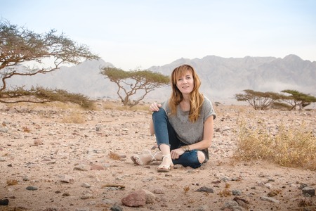 Girl have fun in desert in a summer dayの写真素材