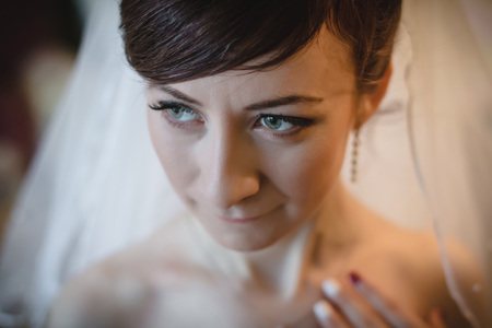 Portrait of slender bride in a white veil indoorsの写真素材