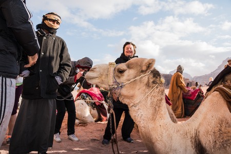 Wadi Rum, Jordan - December, 25, 2017: Tourists and Bedouins near camals in Wadi Rum desert in Jordanのeditorial素材